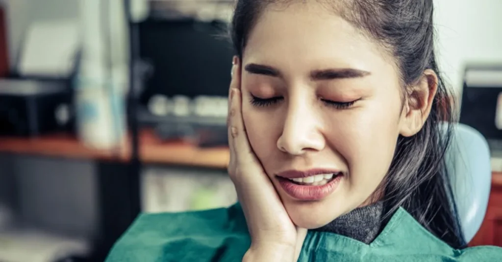 Patient in dental chair with tooth pain needing urgent treatment help